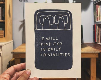 May include: A black and white illustration of two cats in bed with the text "I will find joy in daily trivialities".