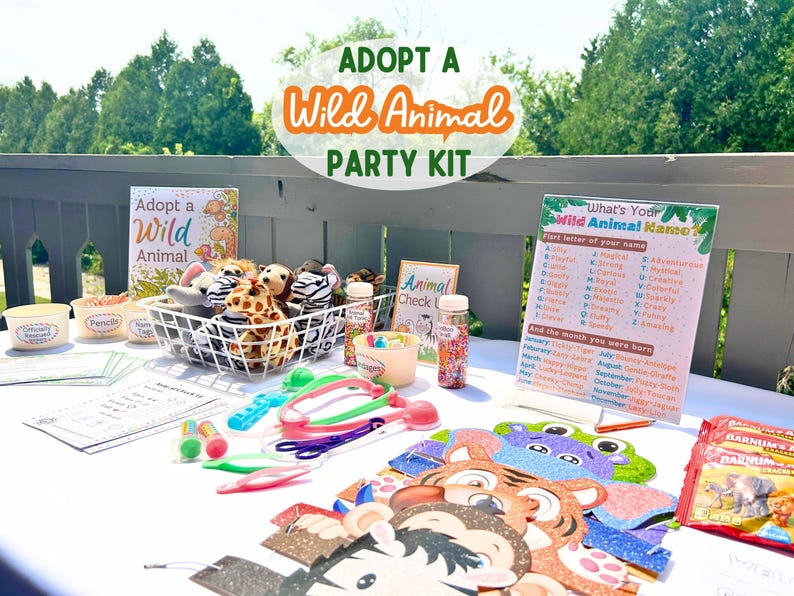 May include: A table set up for a wild animal themed party with stuffed animals, party favors, and a sign that says "What's Your Wild Animal Name?"