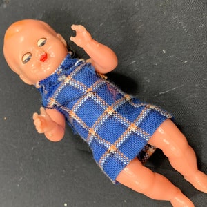 Plastic baby doll with sleeping eyes in a beautiful dress - vintage - excellent condition