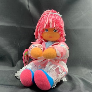 Handmade rag doll in beautiful colours with a felt face and yarn hair.