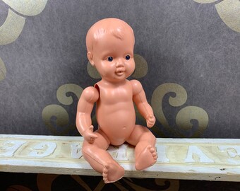 Cutely played doll without clothes - Limbs connected with rope - should be restored.
