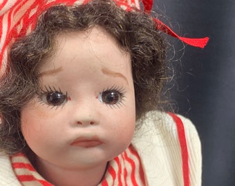 Special antique doll with porcelain head, hands and feet. Her body is made of fabric.