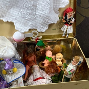 Tin box filled with 19 played with small dolls and toys - tweety - porcelain doll
