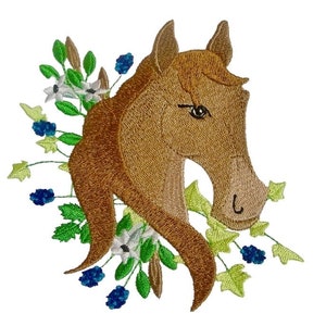May include: Embroidered patch of a brown horse head with green leaves and white flowers, and blue berries.
