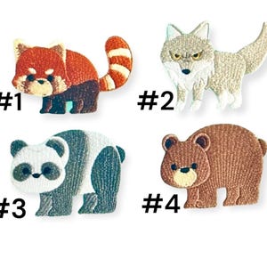 May include: Four embroidered iron-on patches featuring different animals: a red panda, a wolf, a panda bear, and a brown bear. The patches are numbered 1 through 4.