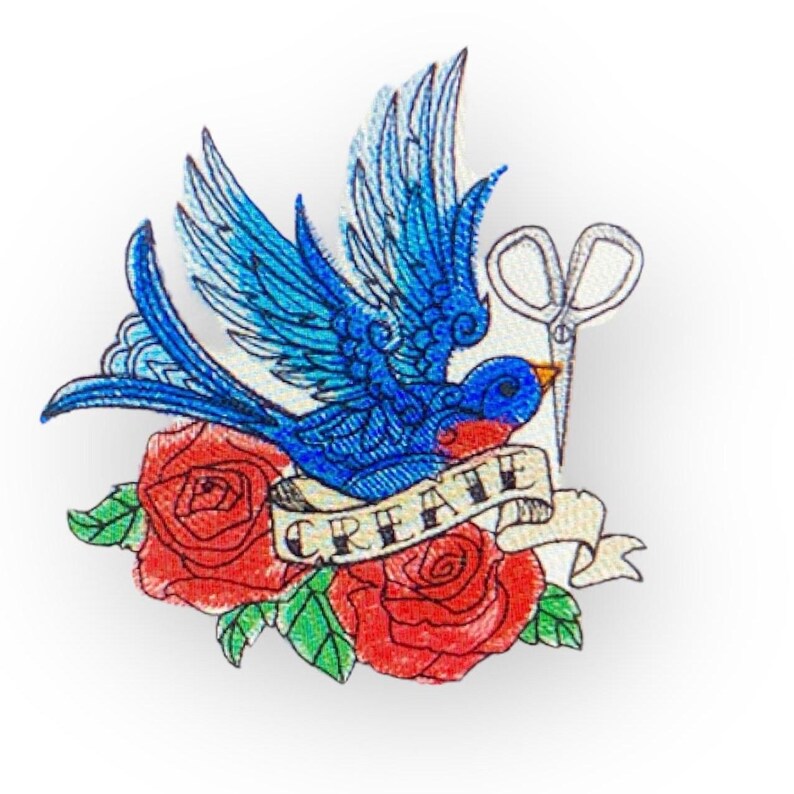 May include: Embroidered iron-on patch featuring a blue bird with red roses and a pair of scissors, with the word "CREATE" on a banner.