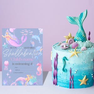 May include: A blue and purple mermaid-themed cake with a mermaid tail on top. The cake is decorated with seashells, starfish, and seaweed. The text on the card reads "An unforgettable Shellabration 'Child's name is swimming 4!"