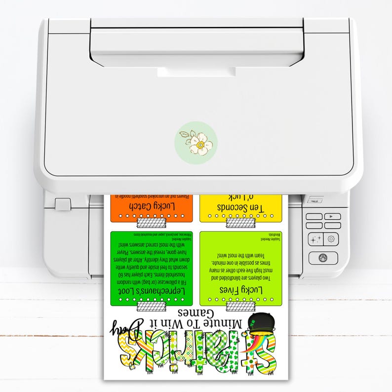 May include: A printer printing a St. Patrick's Day game sheet. The sheet includes four game cards: Lucky Catch, Ten Seconds o' Luck, Lucky Fives, and Leprechaun's Loot. The title "Minute To Win It Games" is also visible.