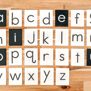 the whole alphabet in lowercase learning toys kit lined up on a wooden table;