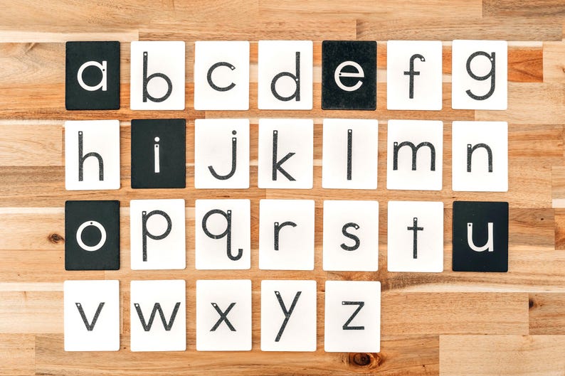 the whole alphabet in lowercase learning toys kit lined up on a wooden table;