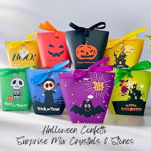 May include: A collection of colorful Halloween-themed gift bags with various designs, including a jack-o'-lantern, a skeleton, and a witch. Each bag is adorned with a ribbon and features the text "Happy Halloween" or "Trick or Treat".