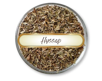 May include: A clear glass bowl filled with dried hyssop herbs. A gold-edged label with the word "Hyssop" in elegant script is centered in the bowl. The herbs are a mix of green and brown, with a detailed texture.