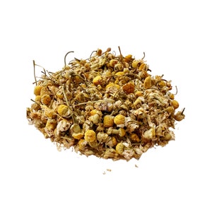 May include: A pile of dried chamomile flowers, featuring small, yellow, and white blossoms with thin, brown stems. The image is set against a clean white background, highlighting the natural texture and color of the herbal tea.