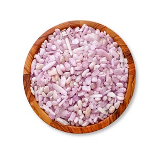 May include: A wooden bowl filled with pink and white tumbled stones. The stones are various shapes and sizes.