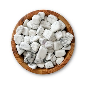 May include: A wooden bowl filled with white howlite tumbled stones. The stones have a natural white and gray marbling pattern.
