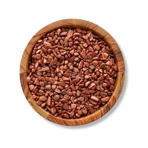 May include: A wooden bowl filled with small, polished, reddish-brown gemstones. The gemstones have a sparkling, metallic appearance, and the bowl is made of light-colored wood with a visible grain. The bowl is round and sits on a white background.