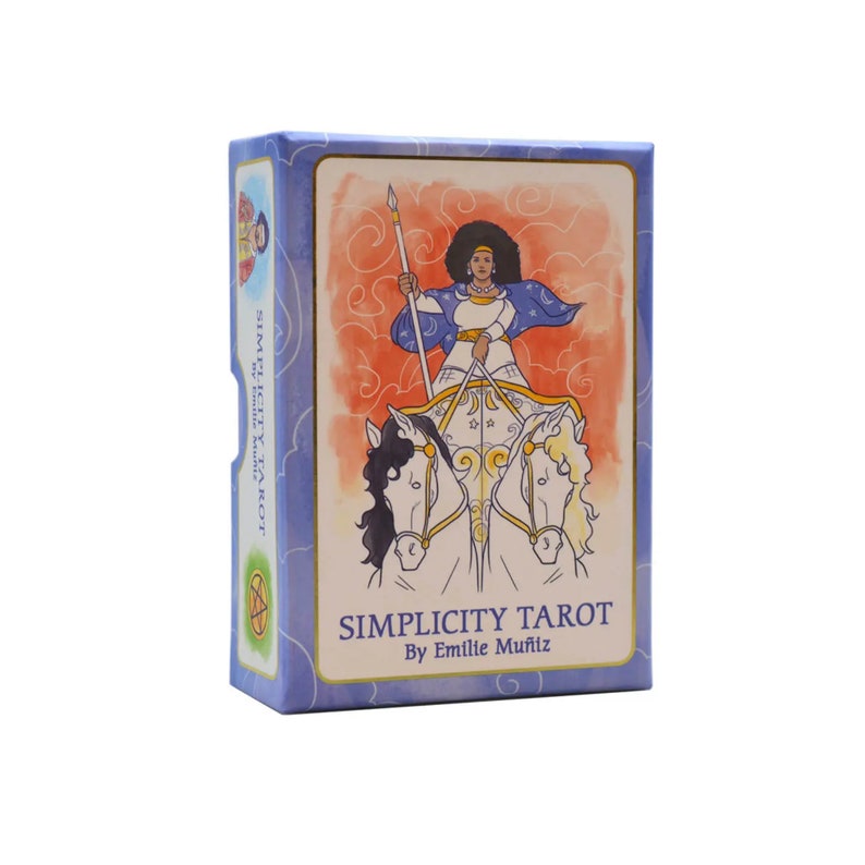 May include: A tarot card deck box with a blue and white design. The front features an illustration of a person in a chariot pulled by two horses. The text "SIMPLICITY TAROT" and "By Emilie Mu&ntilde;iz" are printed on the front.