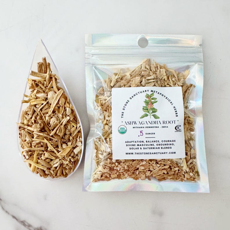 May include: A clear scoop and a sealed bag filled with dried ashwagandha root. The bag has a label with text that reads "ASHWAGANDHA ROOT" and "The Stone Sanctuary Metaphysical Herbs". The bag contains 0.5 ounces of the product.