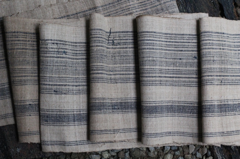 May include: A set of five fabric panels with a striped pattern. The fabric is a natural linen color with dark blue stripes. The panels are folded and arranged in a row.