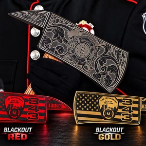 May include: Three decorative axe heads featuring fire department themes. One is silver with floral engravings and the number 9. Two others feature the American flag, the number 343, the text 9-11-2001, and the New York City Fire Department emblem.