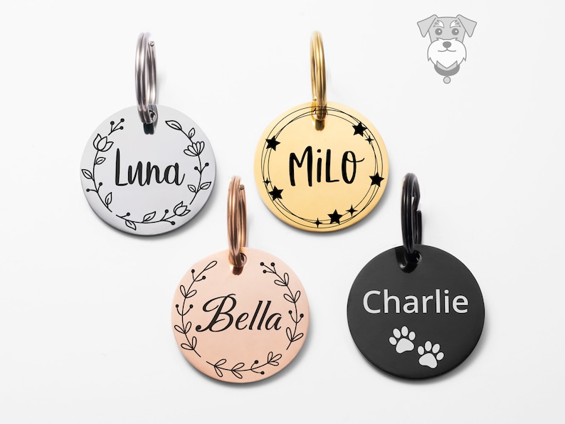 May include: Four personalized dog tags with different designs. The tags are silver, gold, rose gold, and black. The names "Luna", "Milo", "Bella", and "Charlie" are engraved on the tags. The tags have different designs, including flowers, stars, and paw prints.