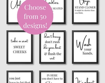 May include: Nine black framed bathroom signs with white text. The signs feature humorous bathroom-related sayings, such as "Take a seat, Sweet Cheeks" and "It's about to go down".