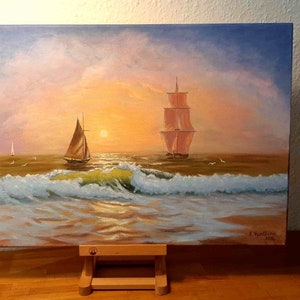 May include: A painting of two sailboats on a calm sea at sunset. The sky is a mix of pink, orange, and blue, with fluffy clouds. The water is a deep blue, with whitecaps and a golden reflection of the sun. The painting is signed "Z. Wantling 2018" in the lower right corner.