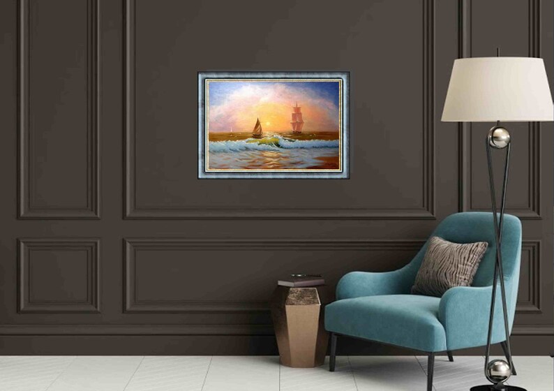 May include: A framed oil painting depicting a sailboat on a calm sea at sunset. The painting features a large ship in the distance and a smaller sailboat in the foreground. The sky is a vibrant orange and pink, and the water is a deep blue.