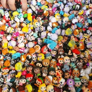 May include: A large collection of colorful miniature figurines, featuring characters from popular animated movies and TV shows. The figurines are made of plastic and have a variety of styles and designs.