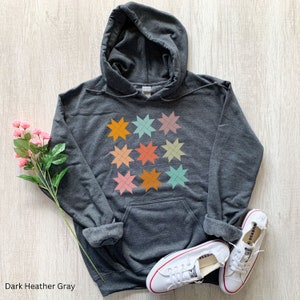 May include: Dark heather gray hooded sweatshirt with a colorful geometric star pattern design.