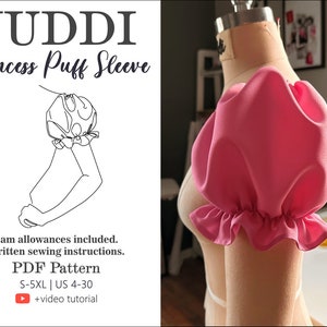 May include: A pink princess puff sleeve sewing pattern with a line drawing illustration of the sleeve. The pattern includes seam allowances and written sewing instructions. The pattern is available in sizes S-5XL and UK sizes 4-30. A video tutorial is also included.