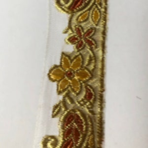 May include: Gold and brown embroidered trim with paisley and floral designs.