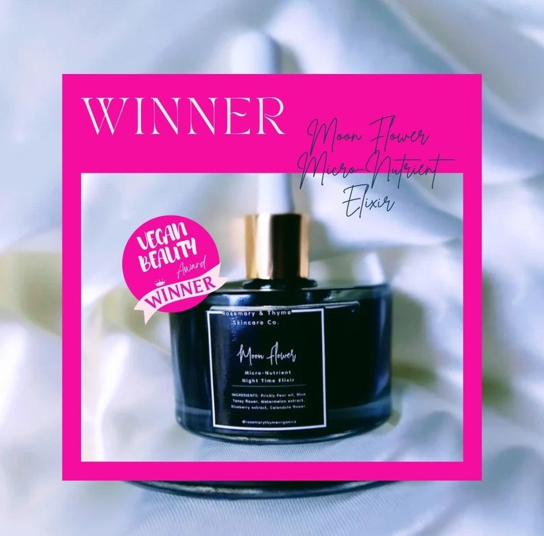 May include: A dark glass dropper bottle labeled Moon Flower Micro-Nutrient Night Time Elixir by Rosemary & Thyme Skincare Co. The bottle features a gold cap and a pink circular sticker that reads Vegan Beauty Award Winner, with Winner text above.