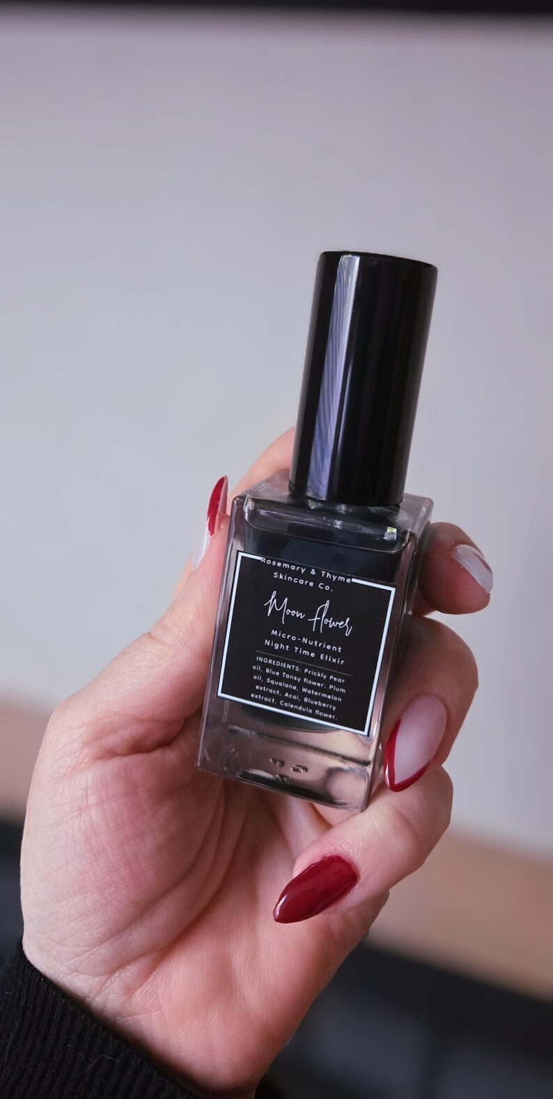 May include: A rectangular glass bottle of Rosemary & Thyme Skincare Co. Moon Flower Micro-Nutrient Night Time Elixir with a black cap. The label lists ingredients including Prickly Pear oil, Blue Tansy flower, Plum oil, Squalane, Watermelon extract, Acai, Blueberry extract, and Calendula flower.