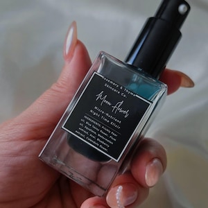 May include: A rectangular glass bottle of Rosemary & Thyme Skincare Co. Moon Flower Micro-Nutrient Night Time Elixir with a black pump dispenser. The label lists ingredients including Prickly Pear oil, Blue Tansy flower, Plum oil, Squalane, Watermelon oil, Acai, Blueberry extract, and Calendula flower.