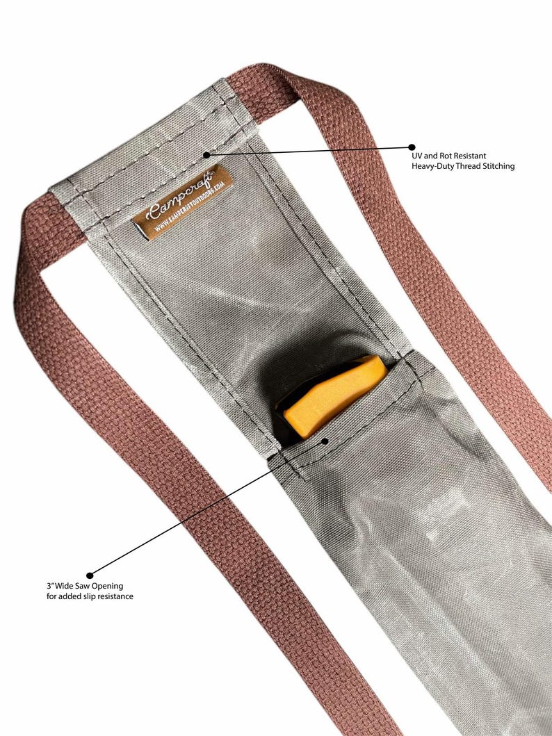 May include: A gray canvas saw holder with two brown straps. The holder has a 3-inch wide opening for added slip resistance. The straps are UV and rot resistant with heavy-duty thread stitching. The text "Campcraft" and "www.campcraftoutdoors.com" is printed on the holder.