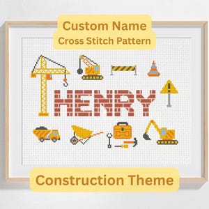 May include: Framed cross-stitch art with a construction theme. The name "HENRY" is displayed in brick-style letters, surrounded by yellow construction vehicles and tools. The text "Custom Name Cross Stitch Pattern" is at the top. The frame is wooden.