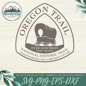 May include: A brown and white graphic design of the Oregon Trail National Historic Trail logo. The logo features a covered wagon, the words "Oregon Trail" in a triangle shape, and the text "Over 2,000 miles thru 7 states Independence, MO to Oregon City, OR National Historic Trail".