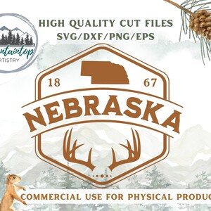 May include: A brown and white graphic design featuring the state of Nebraska with the text "NEBRASKA" in a brown arch above the state. The graphic also includes the numbers "18" and "67" on either side of the state. The graphic is set against a watercolour background of mountains and trees. The text "HIGH QUALITY CUT FILES SVG/DXF/PNG/EPS" appears above the graphic. The text "COMMERCIAL USE FOR PHYSICAL PRODUCTS" appears below the graphic.