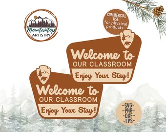 May include: Two brown signs with a welcome to our classroom and enjoy your stay message. The signs have a rustic look with a mountain and bear design. The signs are set against a watercolor background of mountains and trees.