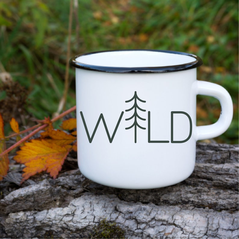 May include: White enamel mug with a black rim and a black and white graphic of a pine tree and the word "WILD".