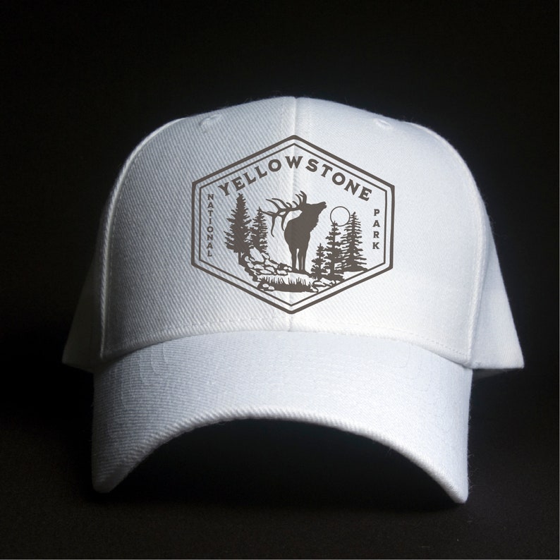 May include: White baseball cap with a brown embroidered patch featuring a silhouette of an elk and the text "Yellowstone National Park".