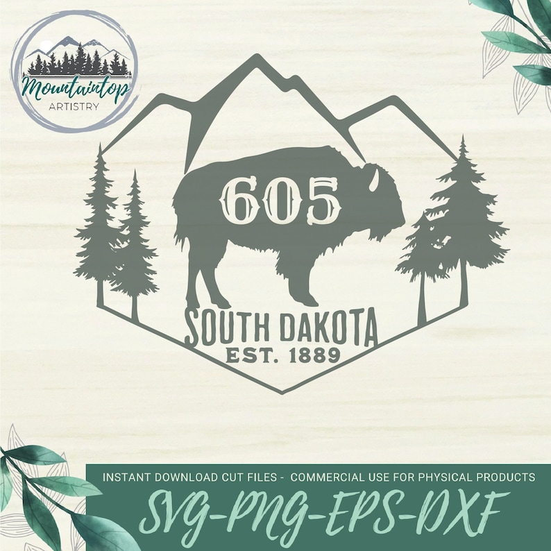 May include: A green and white graphic design featuring a silhouette of a buffalo with the number 605 above it. The text "South Dakota Est. 1889" is below the buffalo. The design is surrounded by a hexagon shape with a mountain range at the top.