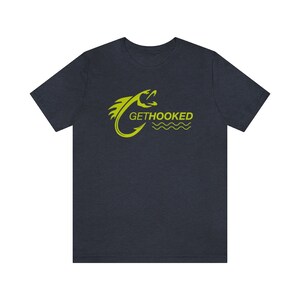 May include: A dark blue t-shirt with a yellow graphic of a fish on a hook with the text "GETHOOKED" underneath.