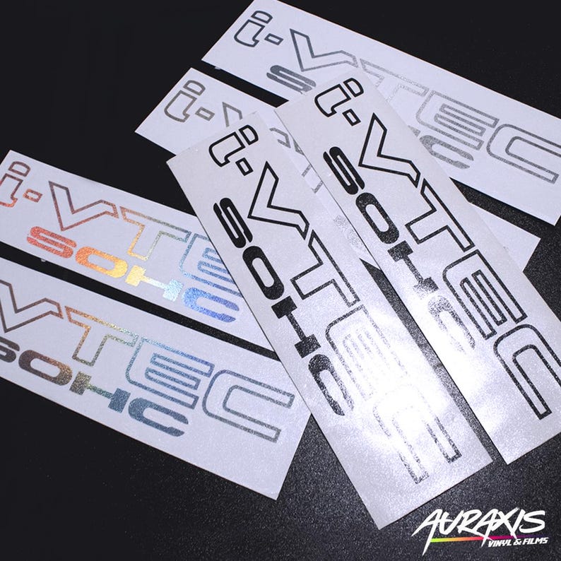 May include: Several white vinyl stickers with the text "i-VTEC SOHC" and "i-VTEC". The stickers have a metallic, holographic, and black finish. The brand name "AURAXIS VINYL & FILMS" is visible in the bottom right corner.