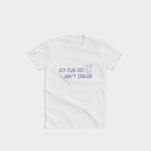 May include: White t-shirt featuring the purple text "DO FUH DO AIN'T OBEAH", along with a skull and wand design. The shirt has a crew neck and short sleeves.