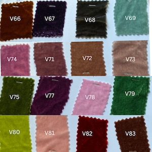 May include: A selection of velvet fabric swatches in a range of colours, such as brown, purple, green, pink, and teal. Each swatch is labelled with a white tag, displaying the different colour options.