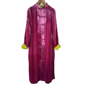 May include: A long-sleeved magenta velvet coat featuring a mandarin collar, a front closure with six fabric-covered toggle buttons, and bright lime green lining visible at the collar and the folded cuffs of the sleeves.