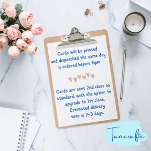 May include: A clipboard with a white sheet of paper with text that reads "Cards will be printed and dispatched the same day if ordered before 6pm. Cards are sent 2nd class as standard. with the option to upgrade to 1st class. Estimated delivery time is 2-3 days." The text is in blue and the background is white. The clipboard is on a white marble surface. The text "Tancraftic" is in blue and is at the bottom of the image.