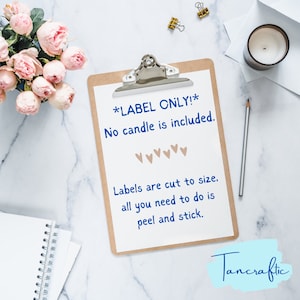 May include: A white clipboard with a brown backing, with the text "*LABEL ONLY!* No candle is included." and "Labels are cut to size. all you need to do is peel and stick."  The text is in blue. There are five small brown hearts below the first line of text. The clipboard is on a white marble surface. The text "Tancraftic" is in blue on a light blue background in the bottom right corner of the image.